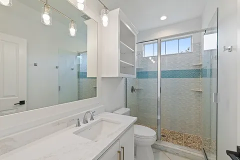 a bathroom with a sink toilet and shower