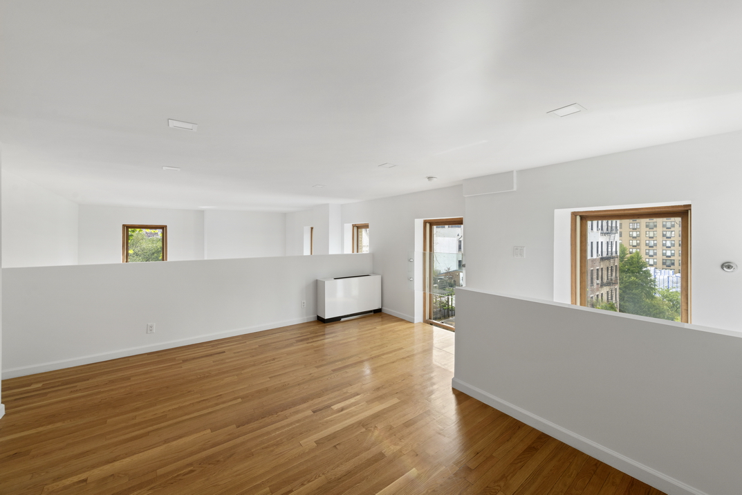 305 2nd Avenue, Unit 505 Manhattan, NY 10003 - Photo 7 of 17 a view of an empty room with wooden floor and a window