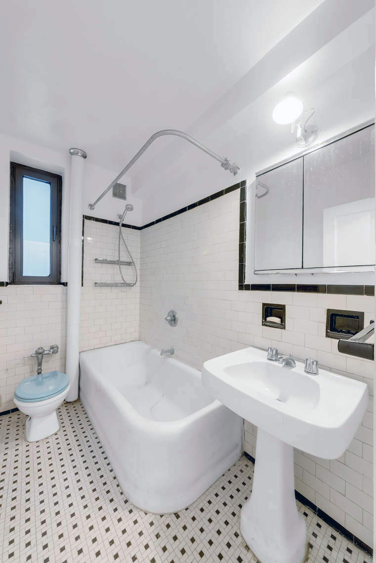 444 Central Park West, Unit 2H Manhattan, NY 10025 - Photo 10 of 16 a bathroom with a sink a toilet and mirror