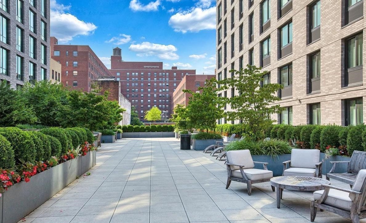 23 West 116th Street, Unit 8A Manhattan, NY 10026 - Photo 20 of 28 a view of a patio with couches and table with potted plants