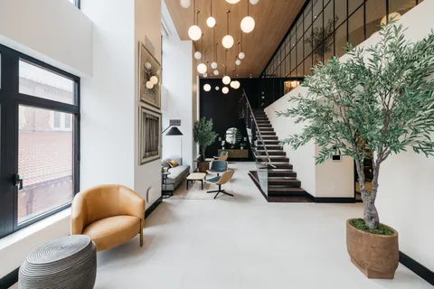a living room with furniture and flowers