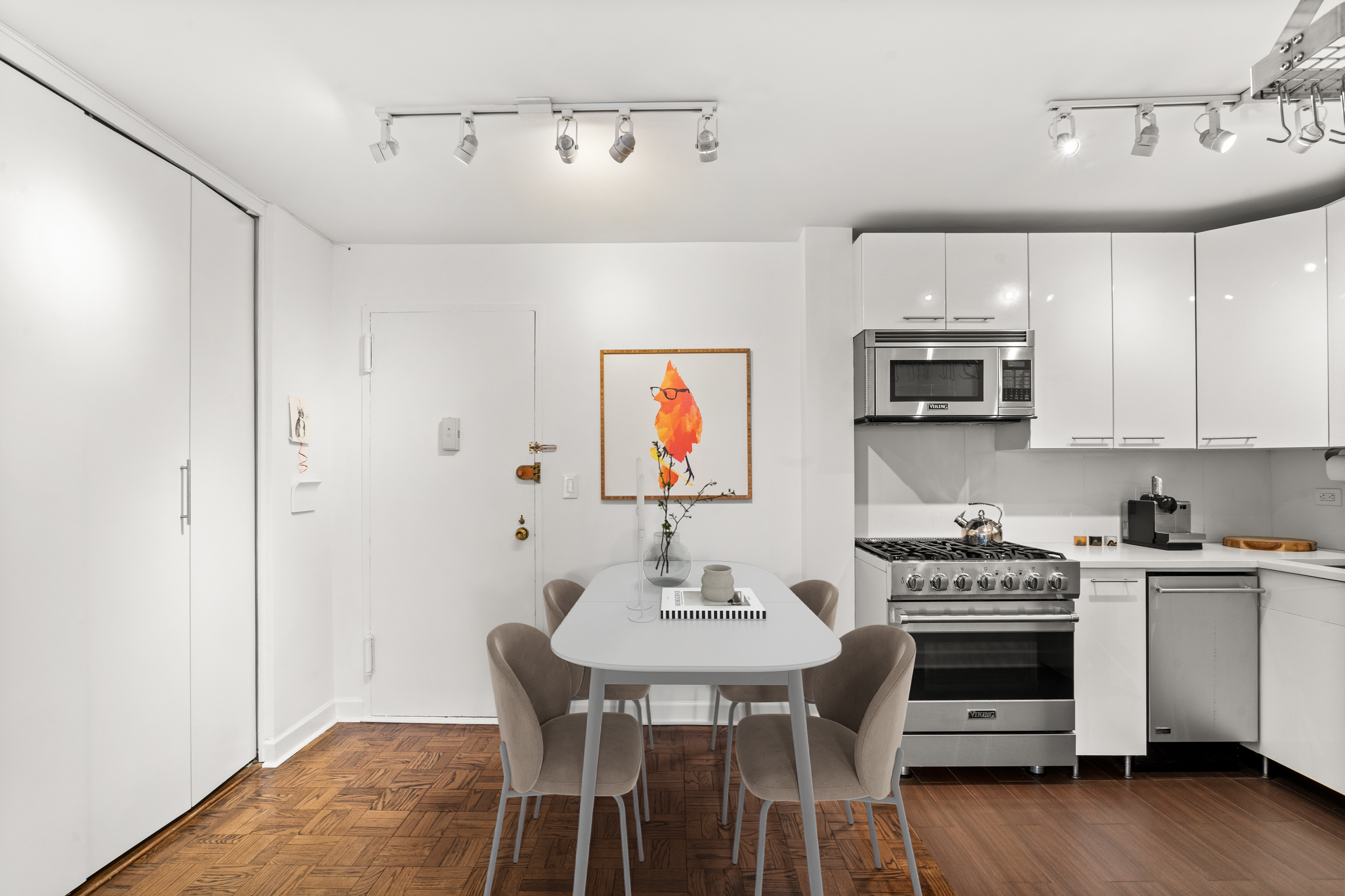 251 East 51st Street, Unit 5A Manhattan, NY 10022 - Photo 9 of 23 a kitchen with stainless steel appliances a stove a sink island and a refrigerator