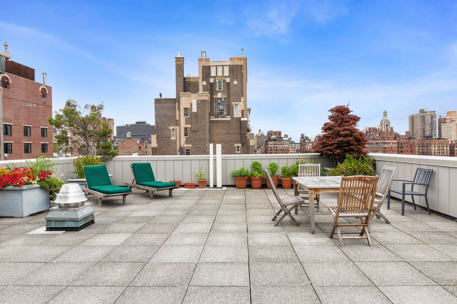 79 West 12th Street, Unit 6BC Manhattan, NY 10011 - Photo 13 of 15 a view of a patio with a table and chairs and potted plants