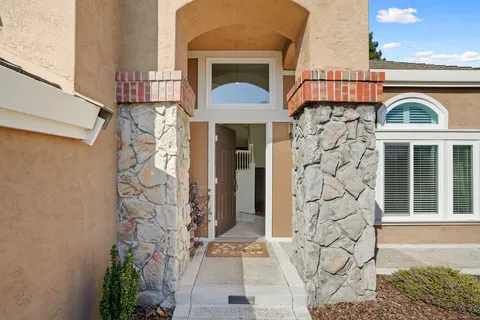 a front view of a house with a garden