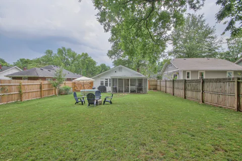 a view of a house with a yard and sitting area
