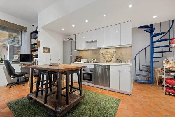a kitchen with stainless steel appliances granite countertop a table chairs sink and cabinets