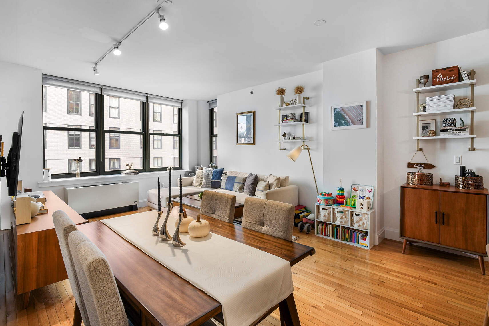 199 State Street, Unit 5C Brooklyn, NY 11201 - Photo 2 of 16 a living room with furniture a flat screen tv and a table