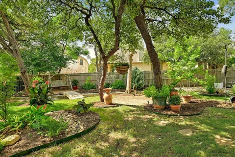 a view of a house with backyard and sitting area