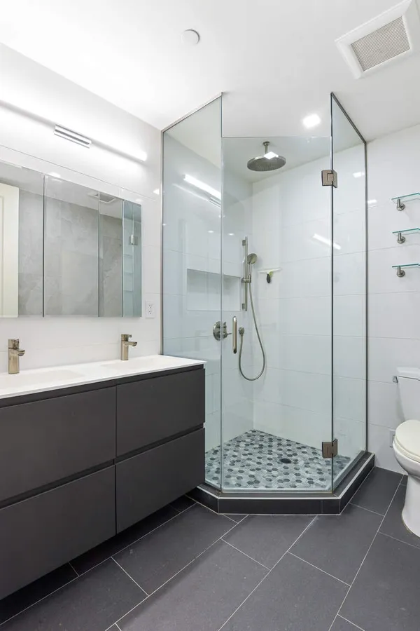 a bathroom with a sink mirror and toilet