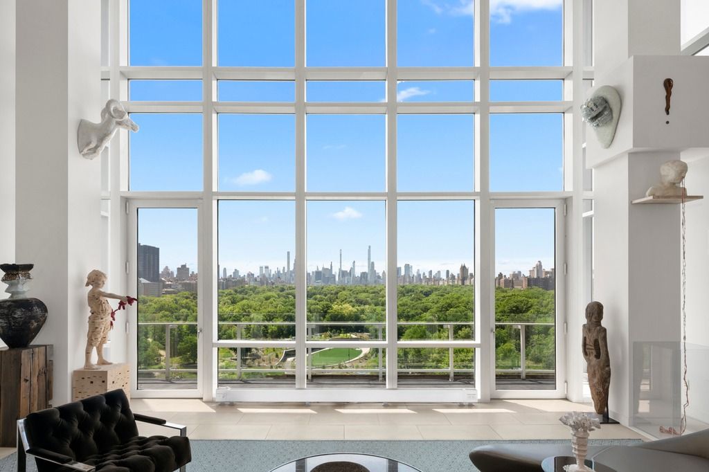 a living room with a floor to ceiling window and floor to ceiling window