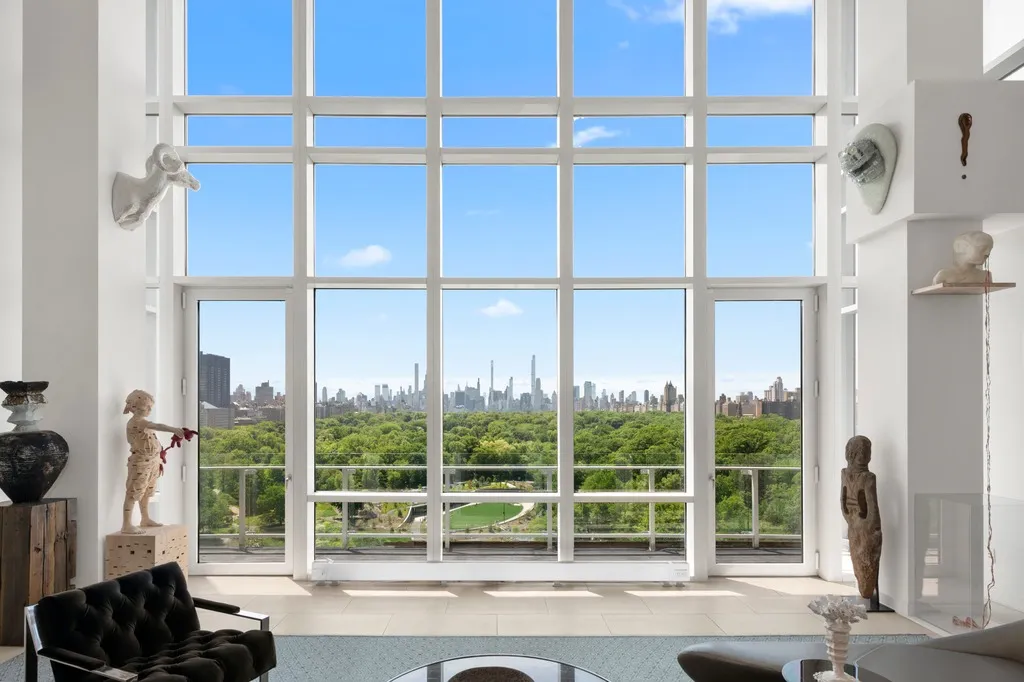 a living room with a floor to ceiling window and floor to ceiling window