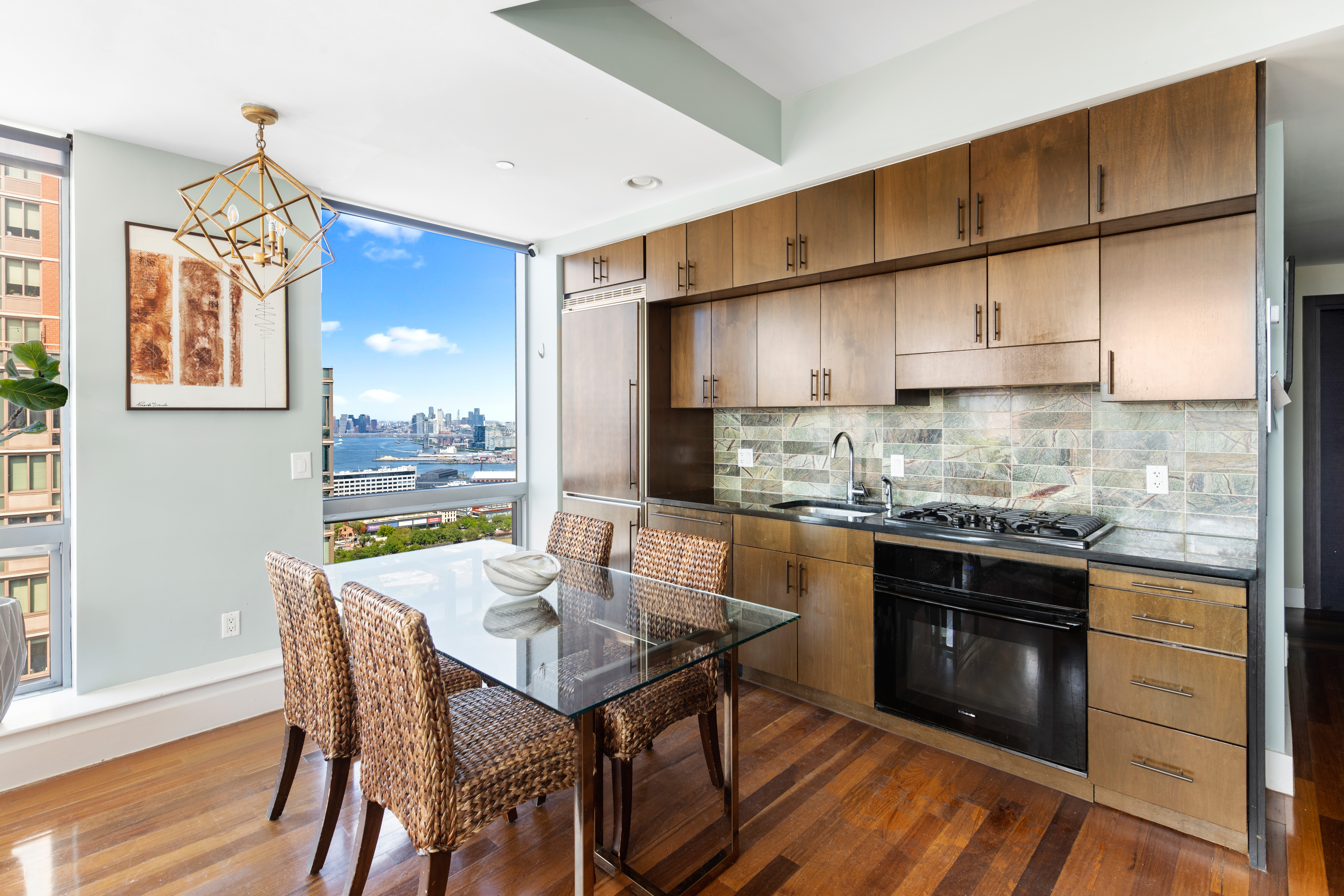 150 Myrtle Avenue, Unit 2903 Brooklyn, NY 11201 - Photo 2 of 14 a kitchen with stainless steel appliances granite countertop a stove a refrigerator a kitchen island a sink dishwasher and white cabinets with wooden floor