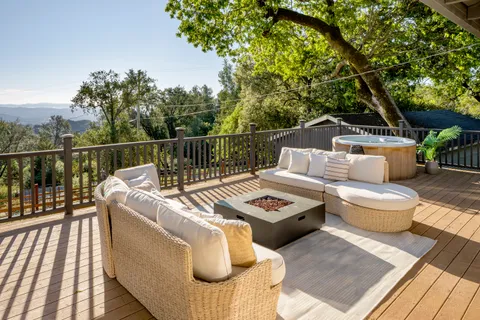 a view of a roof deck with couches and potted plants