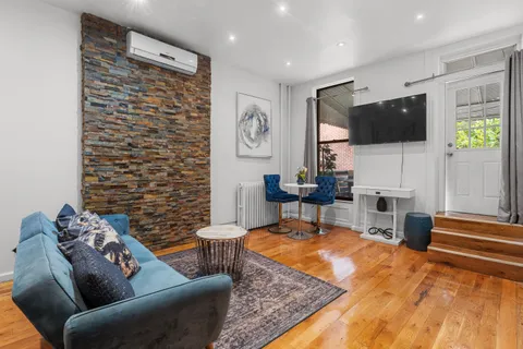 a living room with fireplace furniture and a flat screen tv