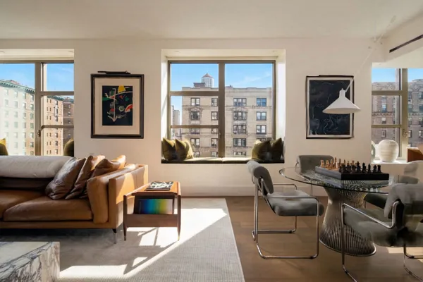 a living room with furniture and floor to ceiling windows