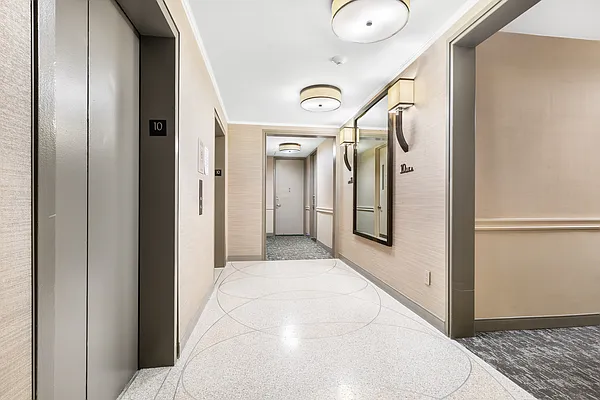 252 7th Avenue, Unit 10I Manhattan, NY 10001 - Photo 17 of 25 a view of a hallway with wooden floor and glass door