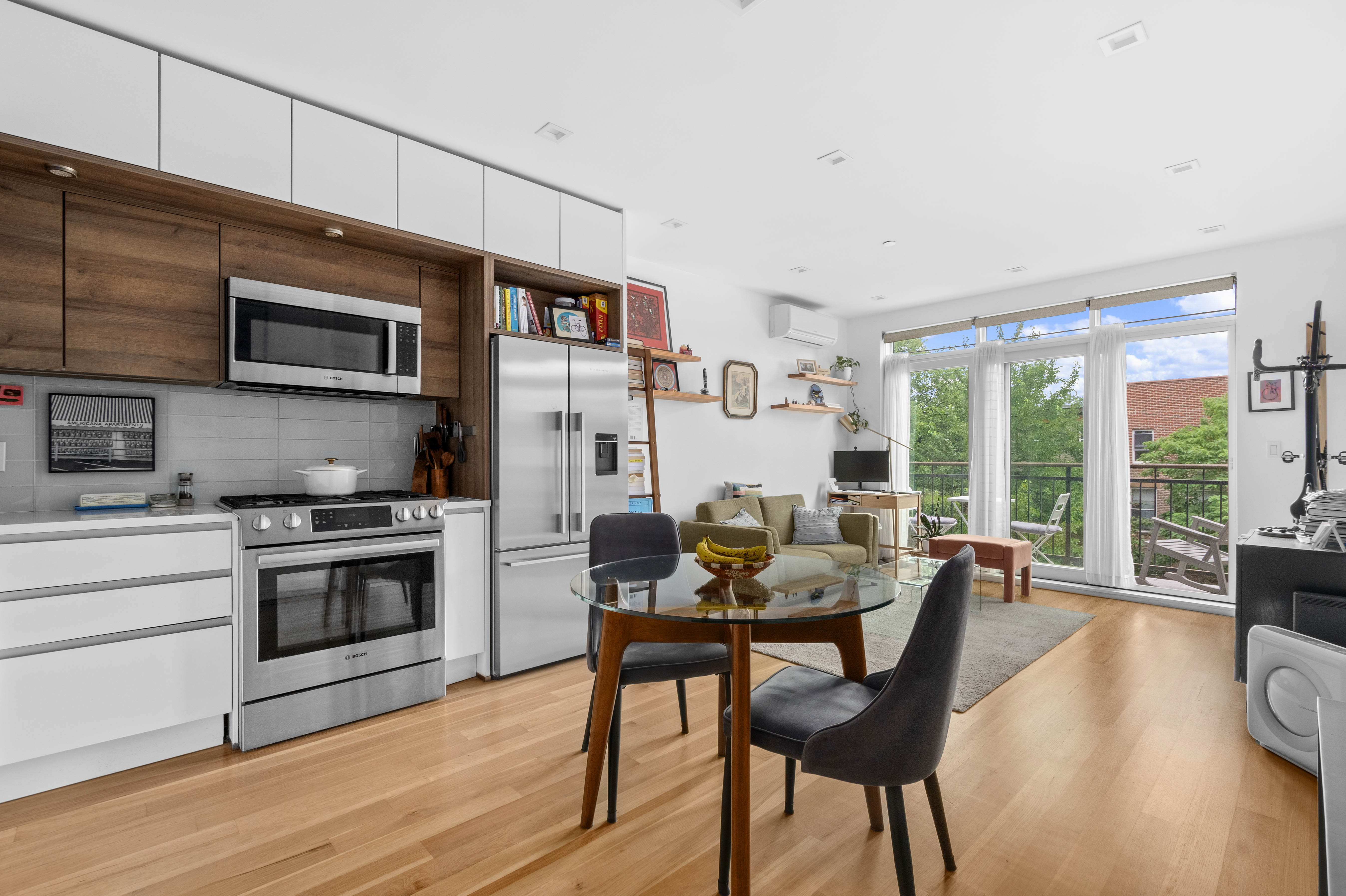 203 Quincy Street, Unit 4B Brooklyn, NY 11216 - Photo 1 of 11 a dining room with furniture a fireplace and wooden floor