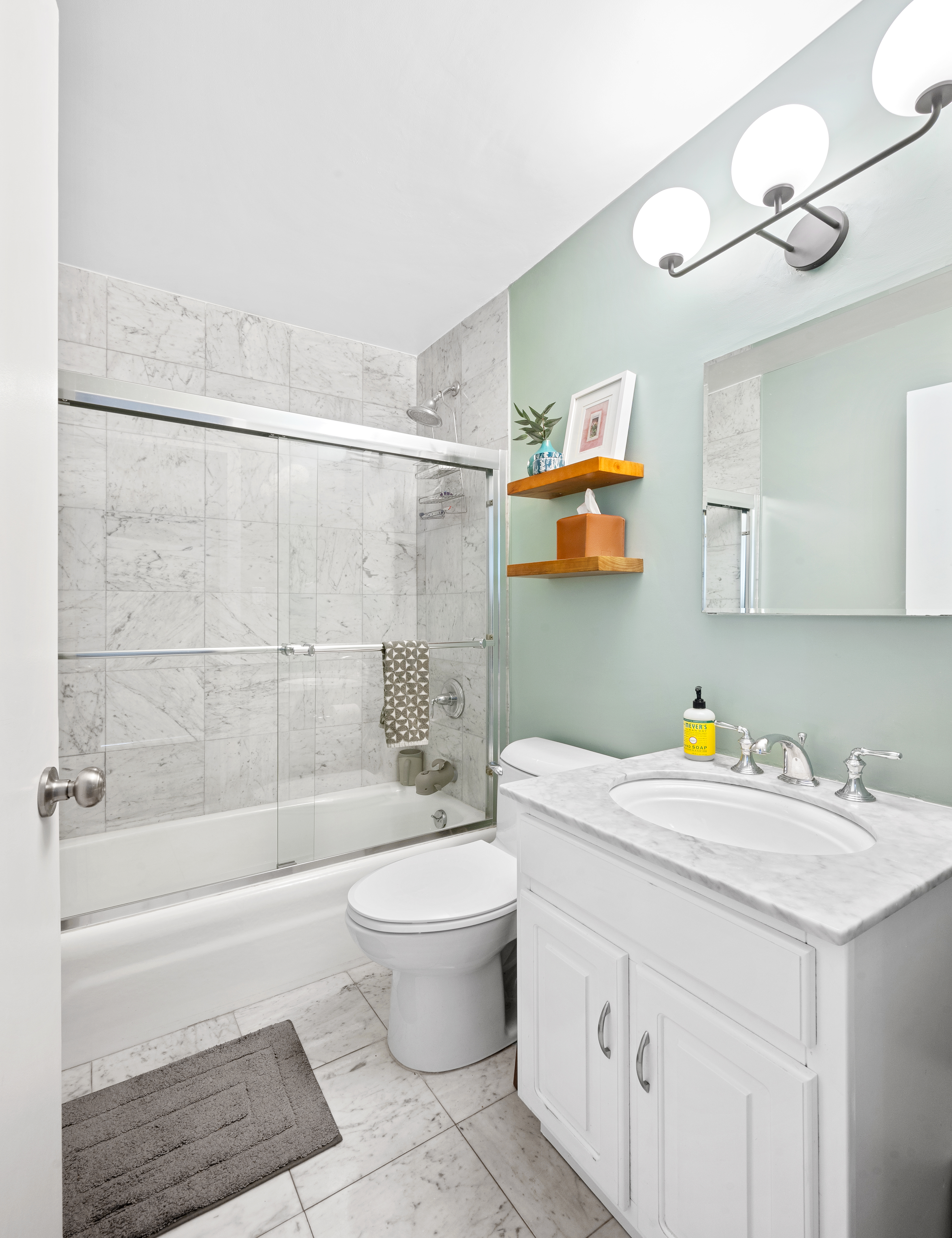 245 East 54th Street, Unit 26JK Manhattan, NY 10022 - Photo 6 of 12 a bathroom with a sink a toilet and shower