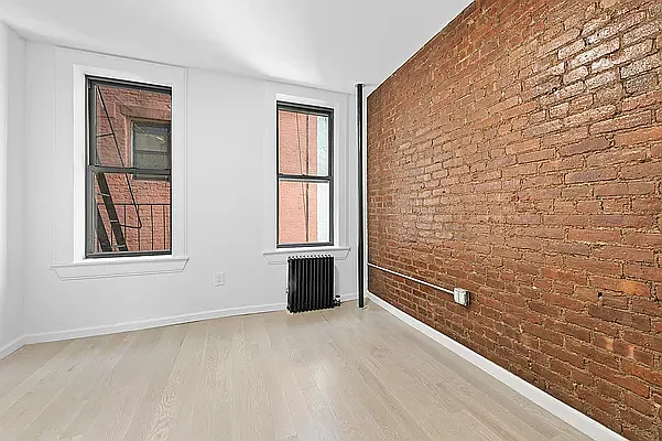 117 Mulberry Street, Unit 9 Manhattan, NY 10013 - Photo 3 of 5 a view of an empty room with a window