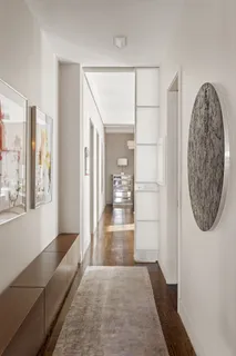 a view of entryway with wooden floor and mirror