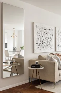 a living room with a couch and a potted plant on a dresser