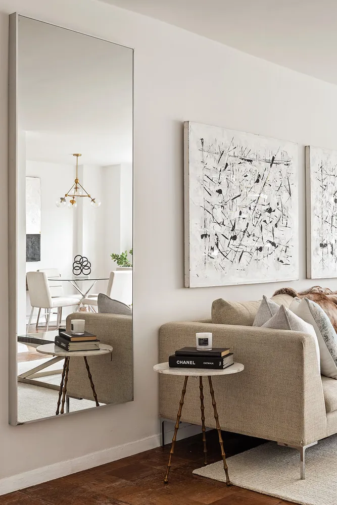 a living room with a couch and a potted plant on a dresser