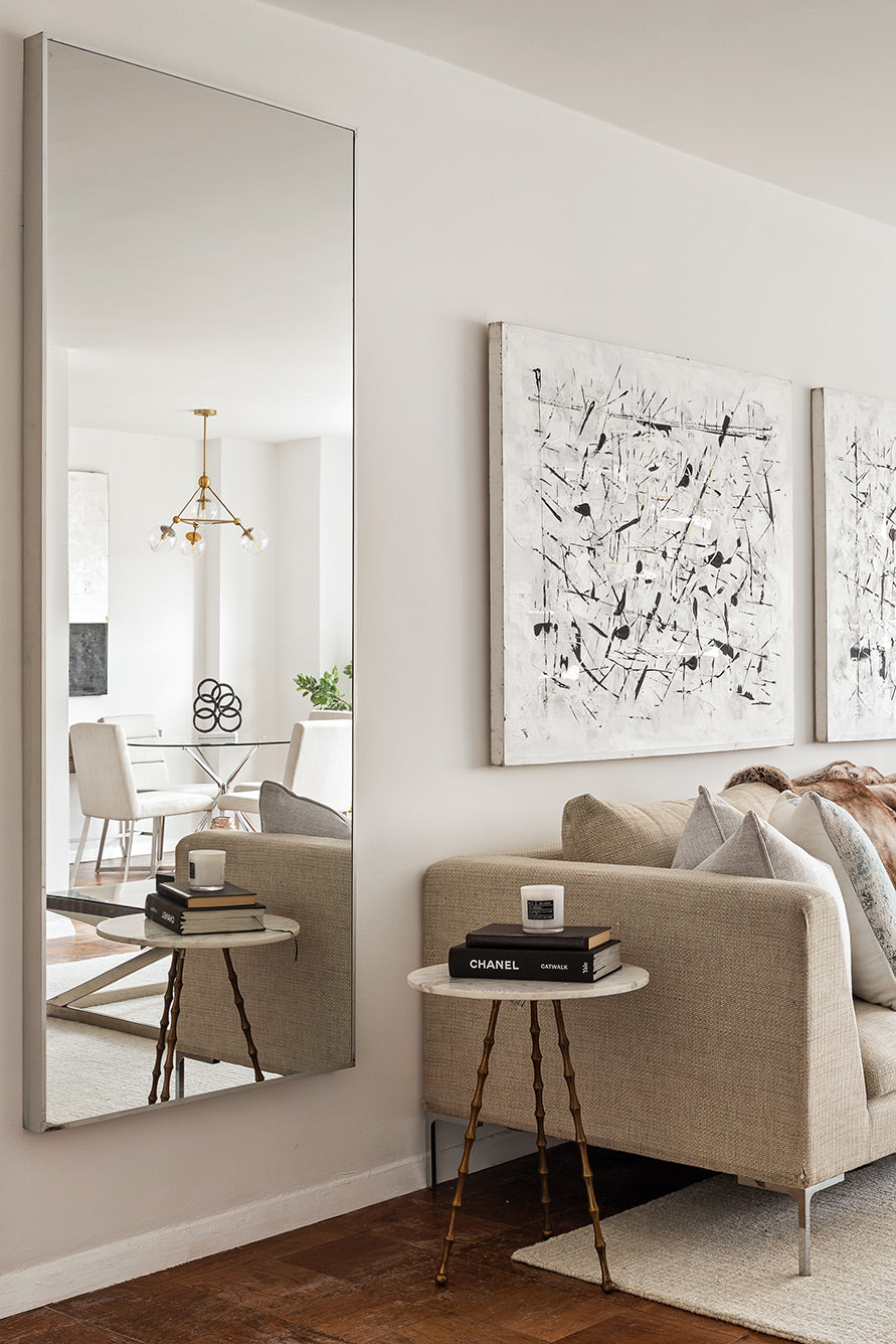 185 West End Avenue, Unit 16D Manhattan, NY 10023 - Photo 3 of 11 a living room with a couch and a potted plant on a dresser