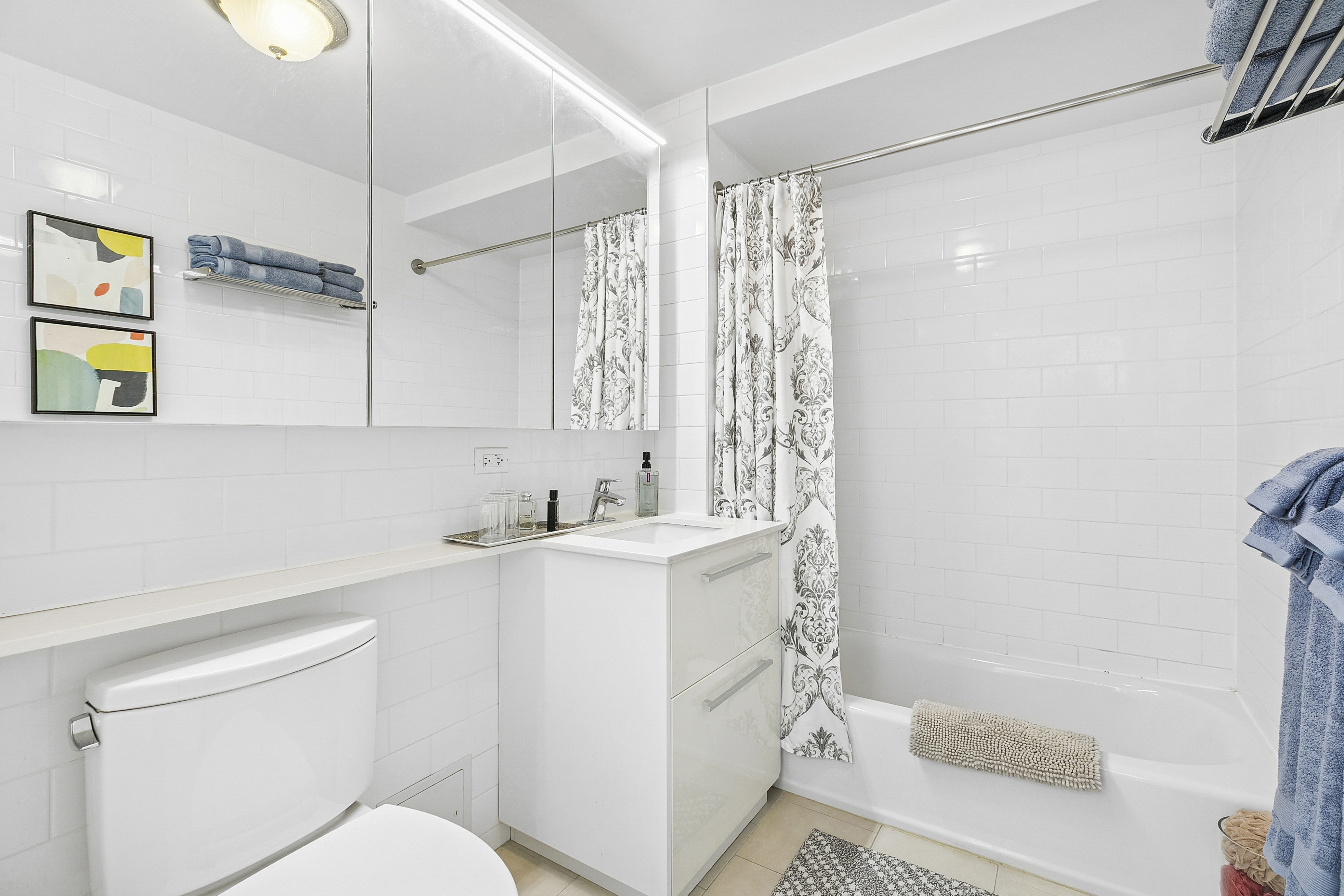 51 East 131st Street, Unit 6A Manhattan, NY 10037 - Photo 5 of 9 a bathroom with a sink a toilet and shower