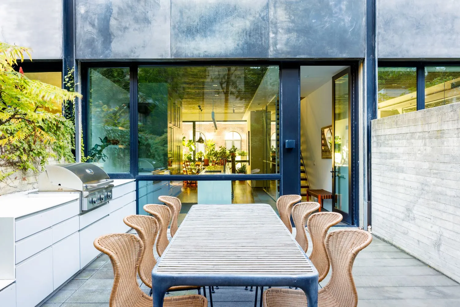 a dining room with furniture and a large window