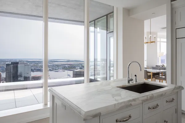 a kitchen with a large window and a sink