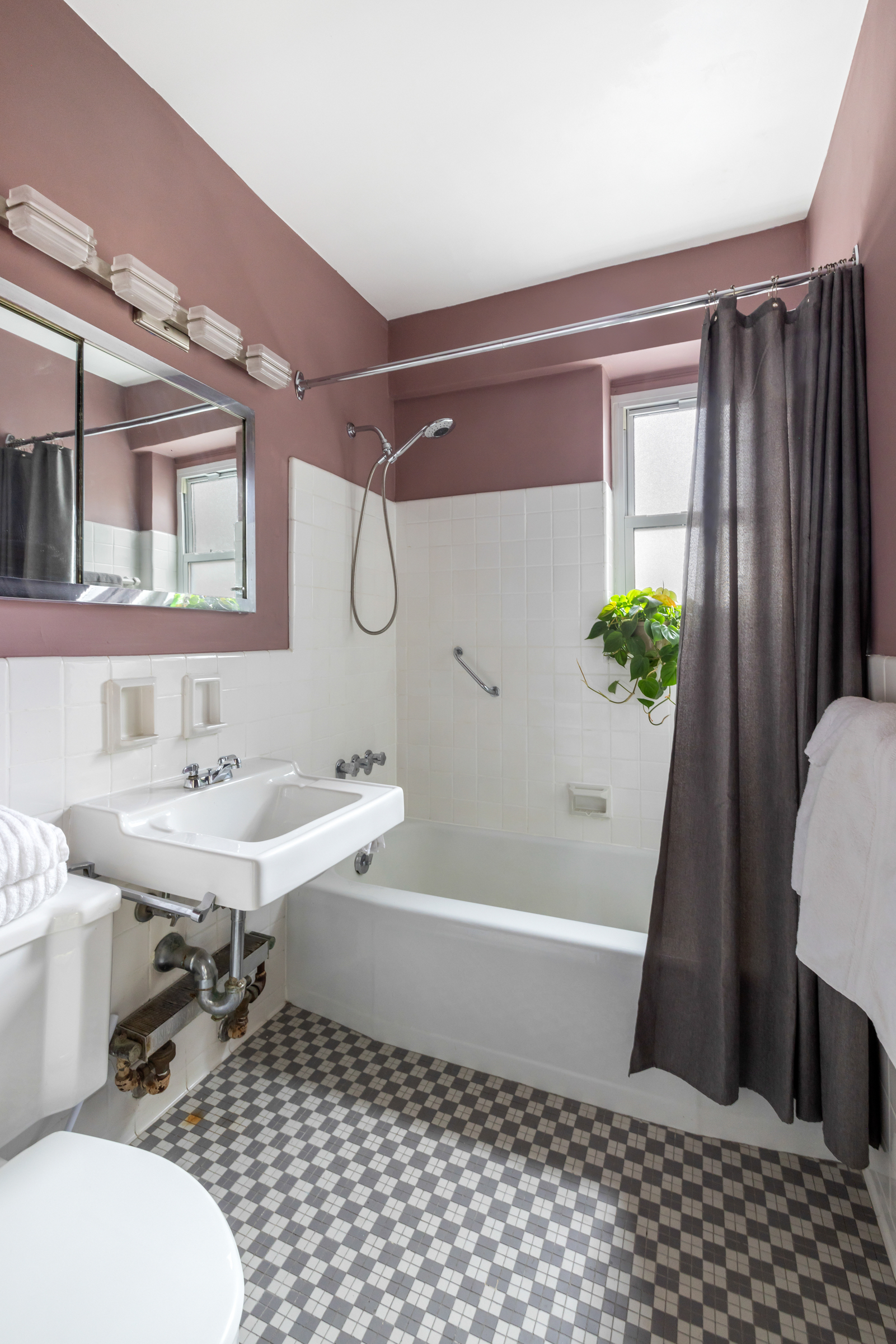 16 Sutton Place, Unit 11A Manhattan, NY 10022 - Photo 10 of 19 a bathroom with a sink a toilet a mirror and shower