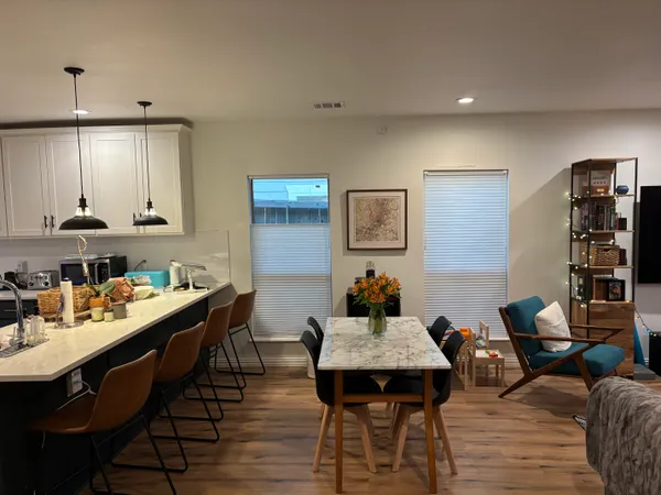 a view of a dining room with furniture and wooden floor