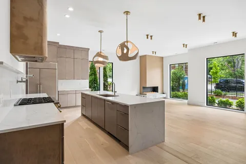 a kitchen with a sink a stove and a refrigerator