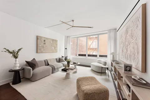 a living room with furniture and floor to ceiling windows