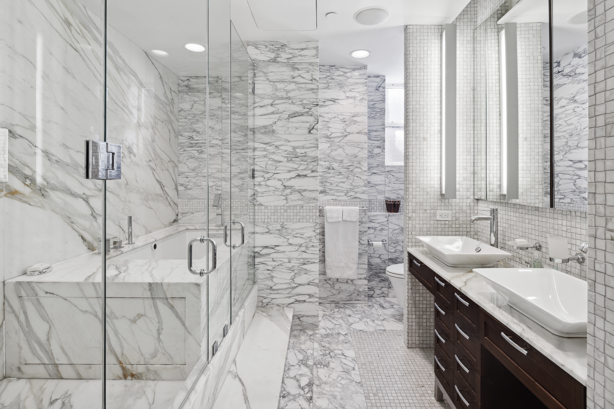 561 Broadway, Unit 10C Manhattan, NY 10012 - Photo 8 of 11 a bathroom with a granite countertop sink a mirror and shower