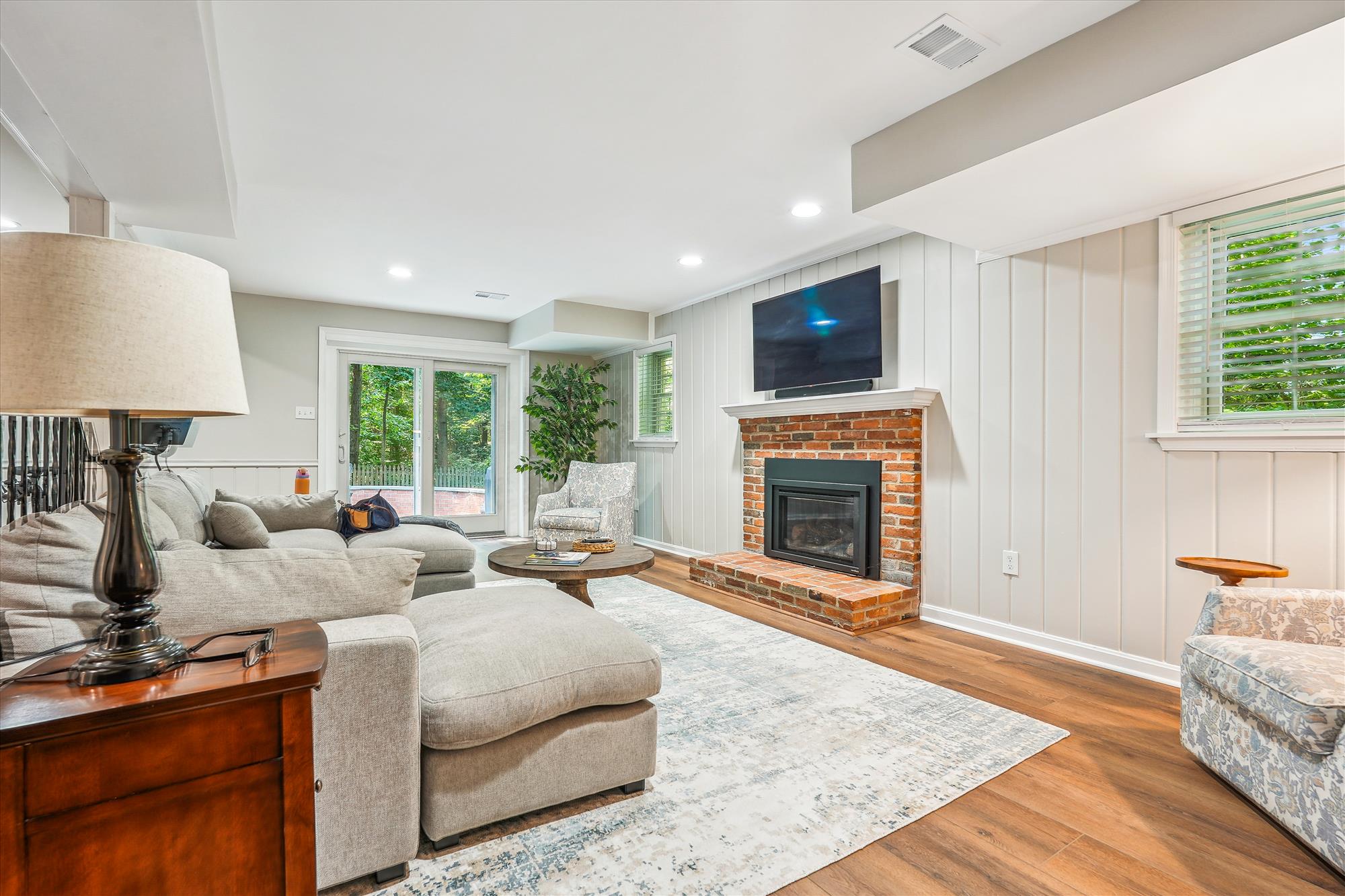 9904 Carter Road Bethesda, MD 20817 - Photo 32 of 41 a living room with furniture a flat screen tv and a fireplace