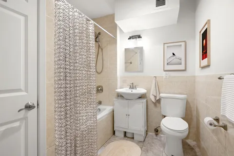 a white toilet sitting next to a bathroom sink