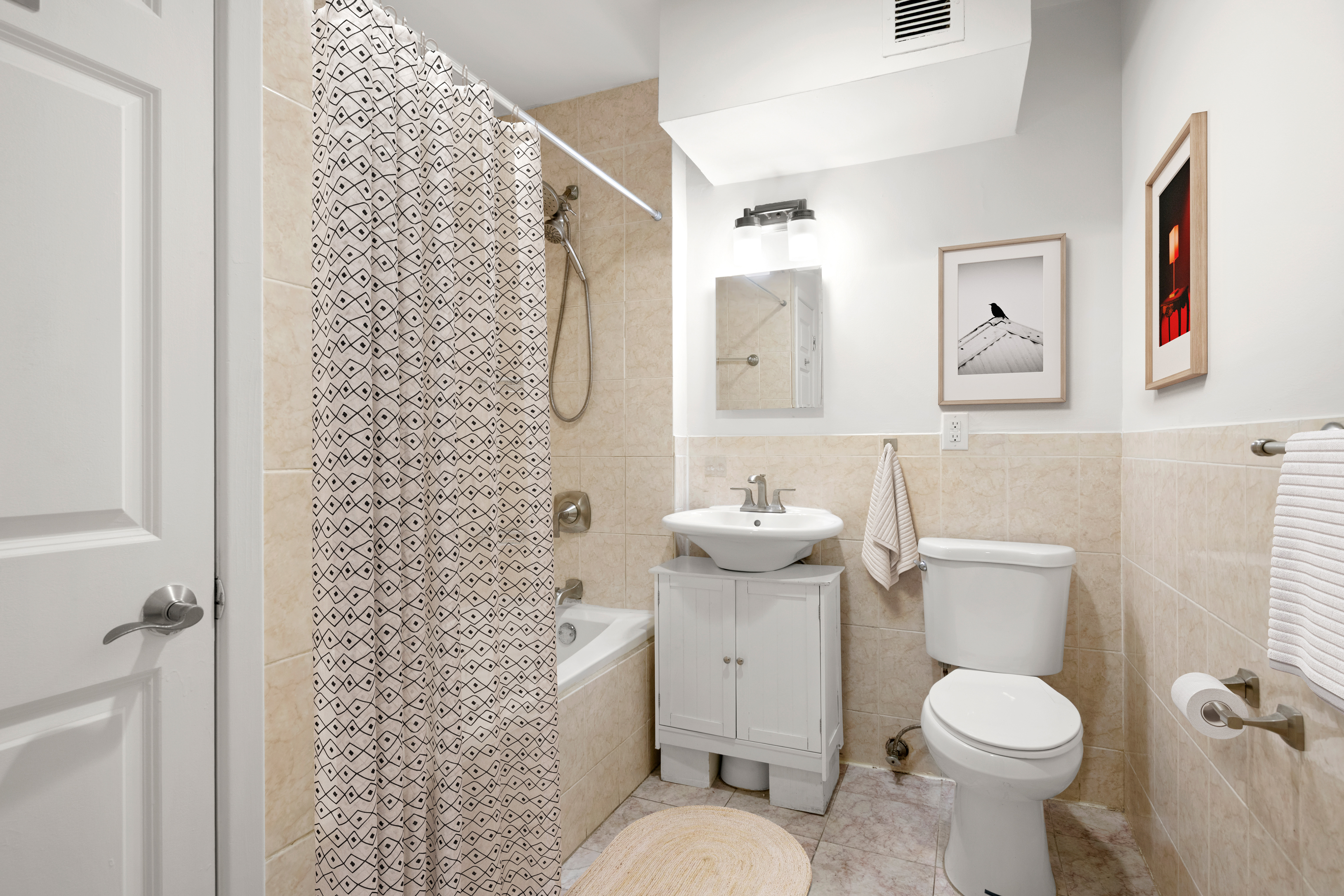 1240 Bedford Avenue, Unit 3H Brooklyn, NY 11216 - Photo 10 of 12 a white toilet sitting next to a bathroom sink