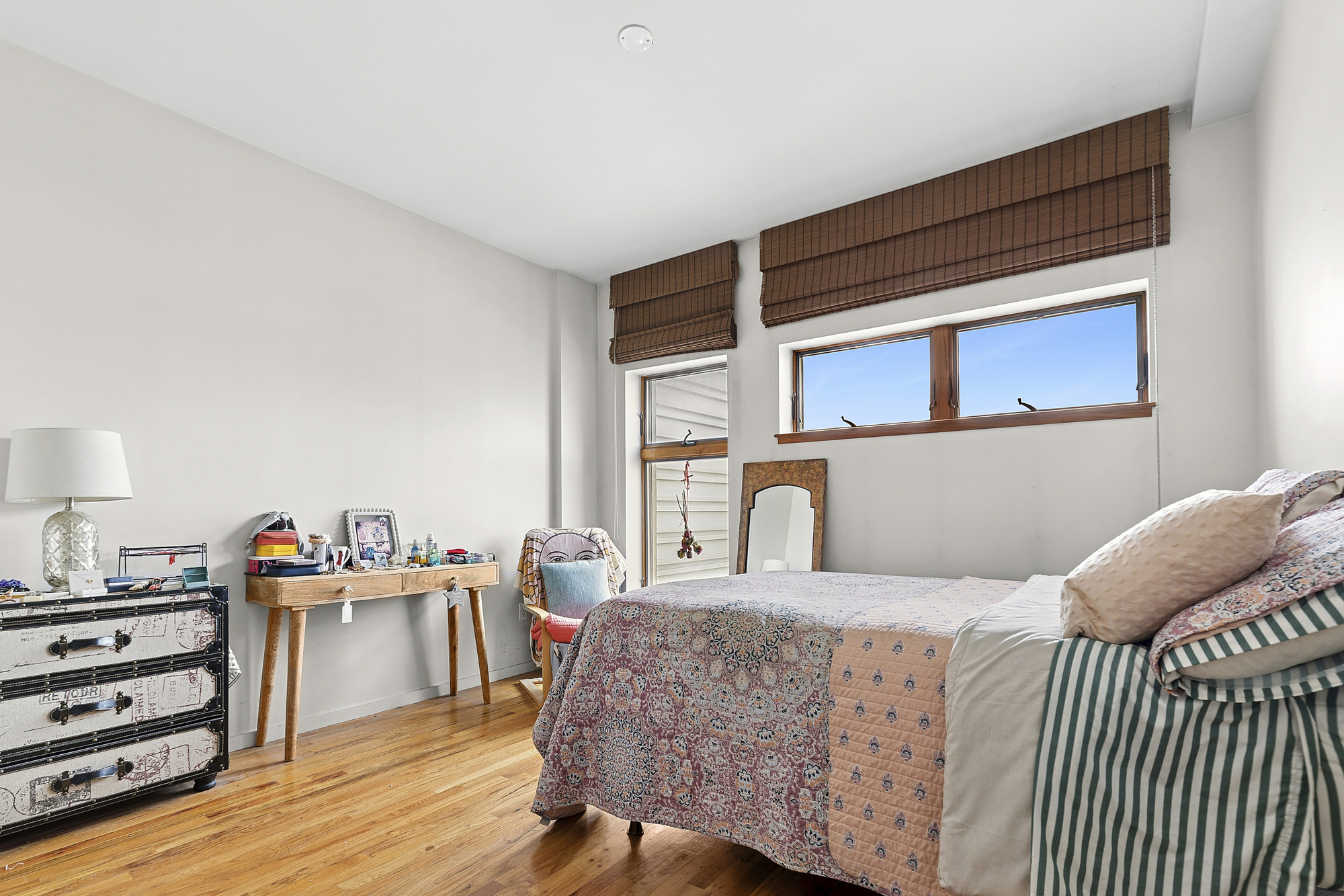 14-25 Broadway, Unit 5R Queens, NY 11106 - Photo 4 of 5 a bedroom with a bed and wooden floor