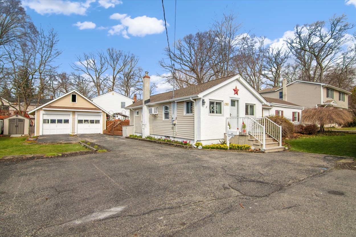 107 Kingston Road Parsippany, NJ 07054 - Photo 37 of 43 a view of a house with a yard and large tree