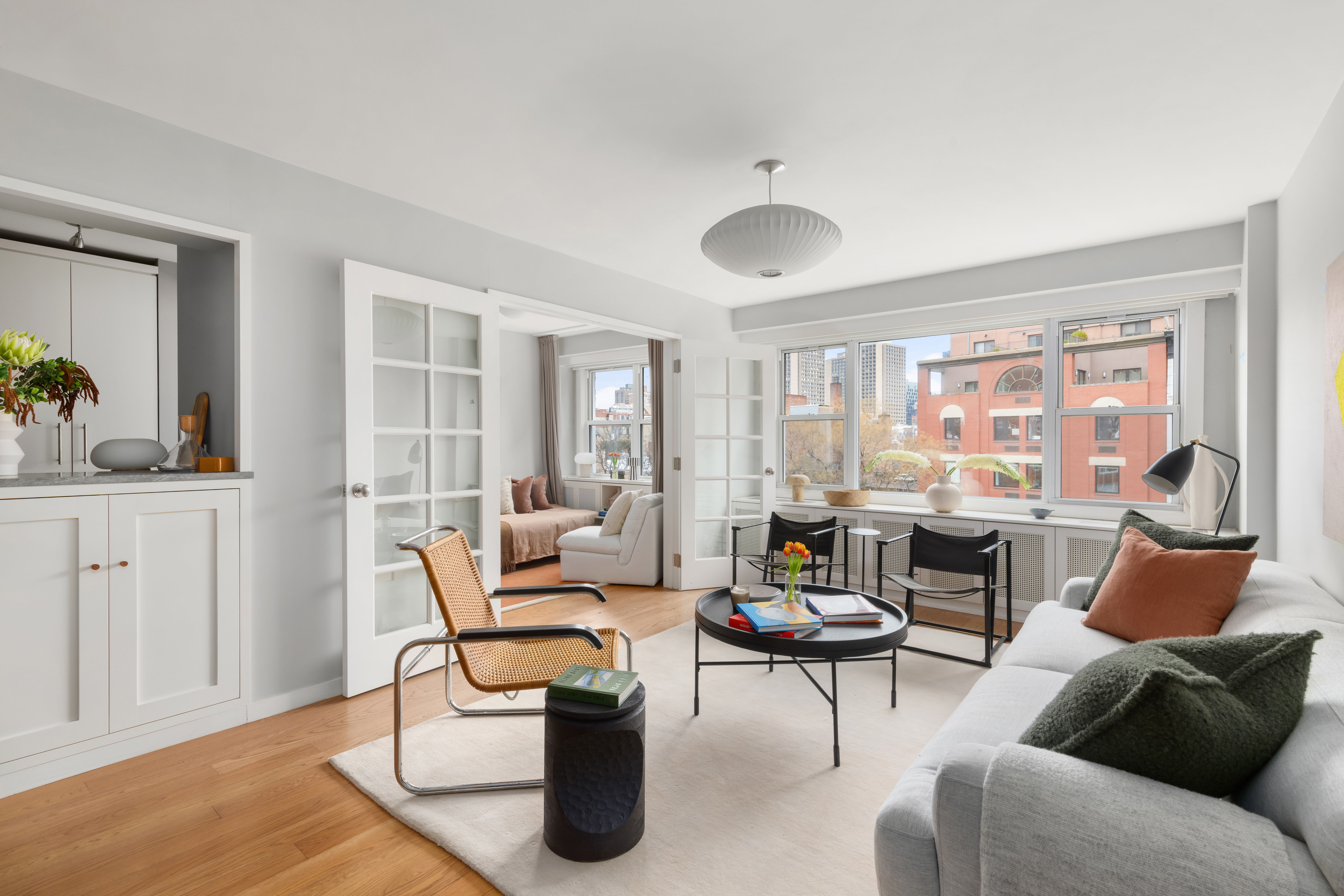 2 Charlton Street, Unit 7J Manhattan, NY 10014 - Photo 2 of 15 a living room with furniture and a large window