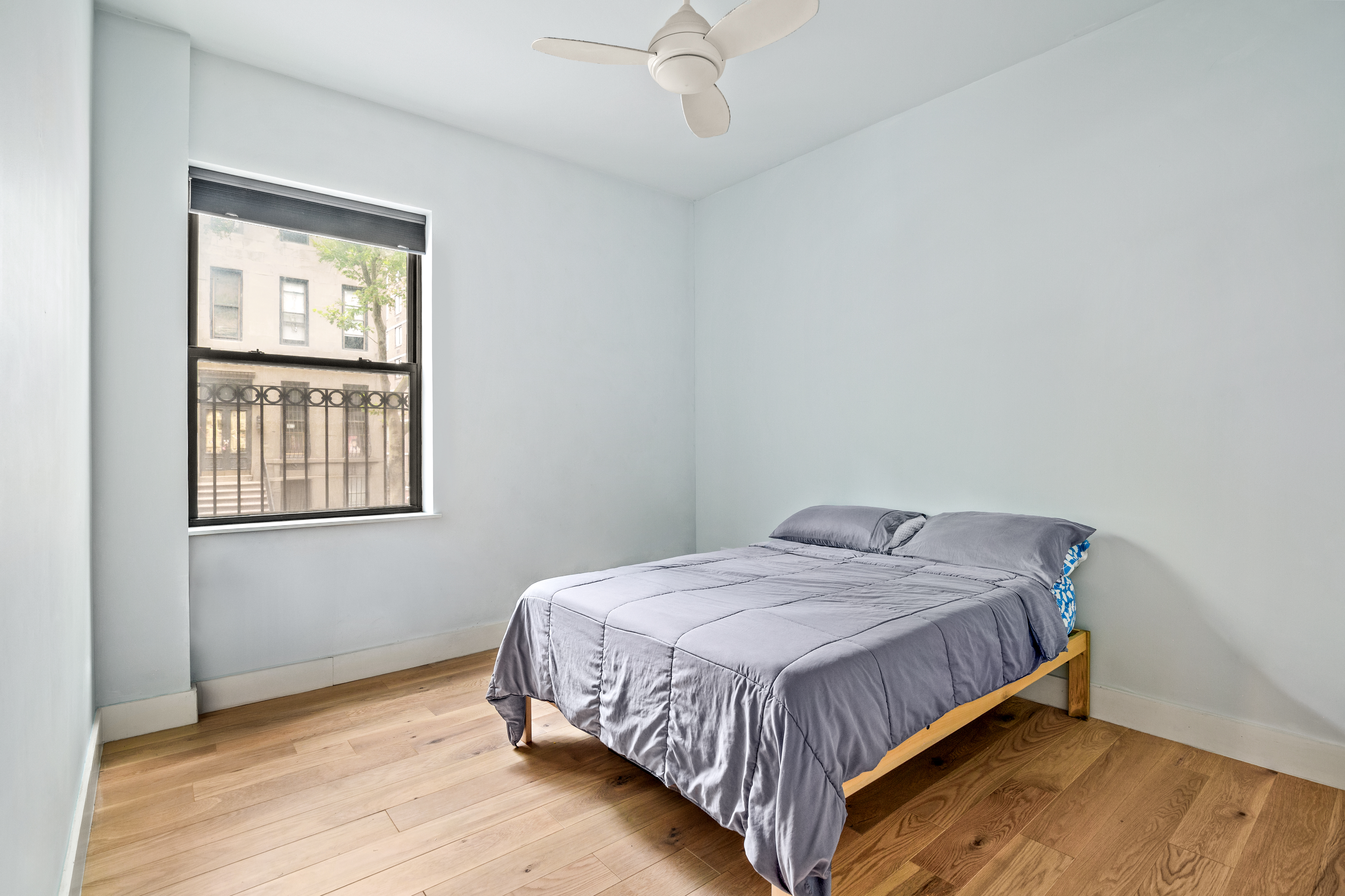 170 East 94th Street, Unit 1C Manhattan, NY 10128 - Photo 6 of 9 a bed sitting in a bedroom next to a window