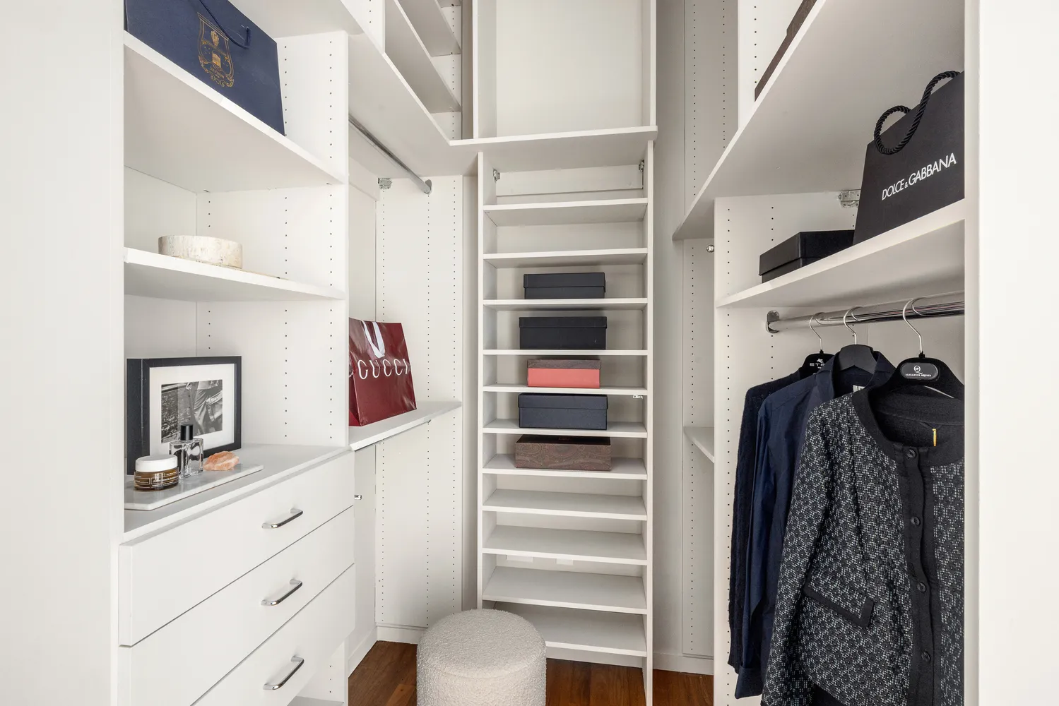 a view of walk in closet with clothes and shoes