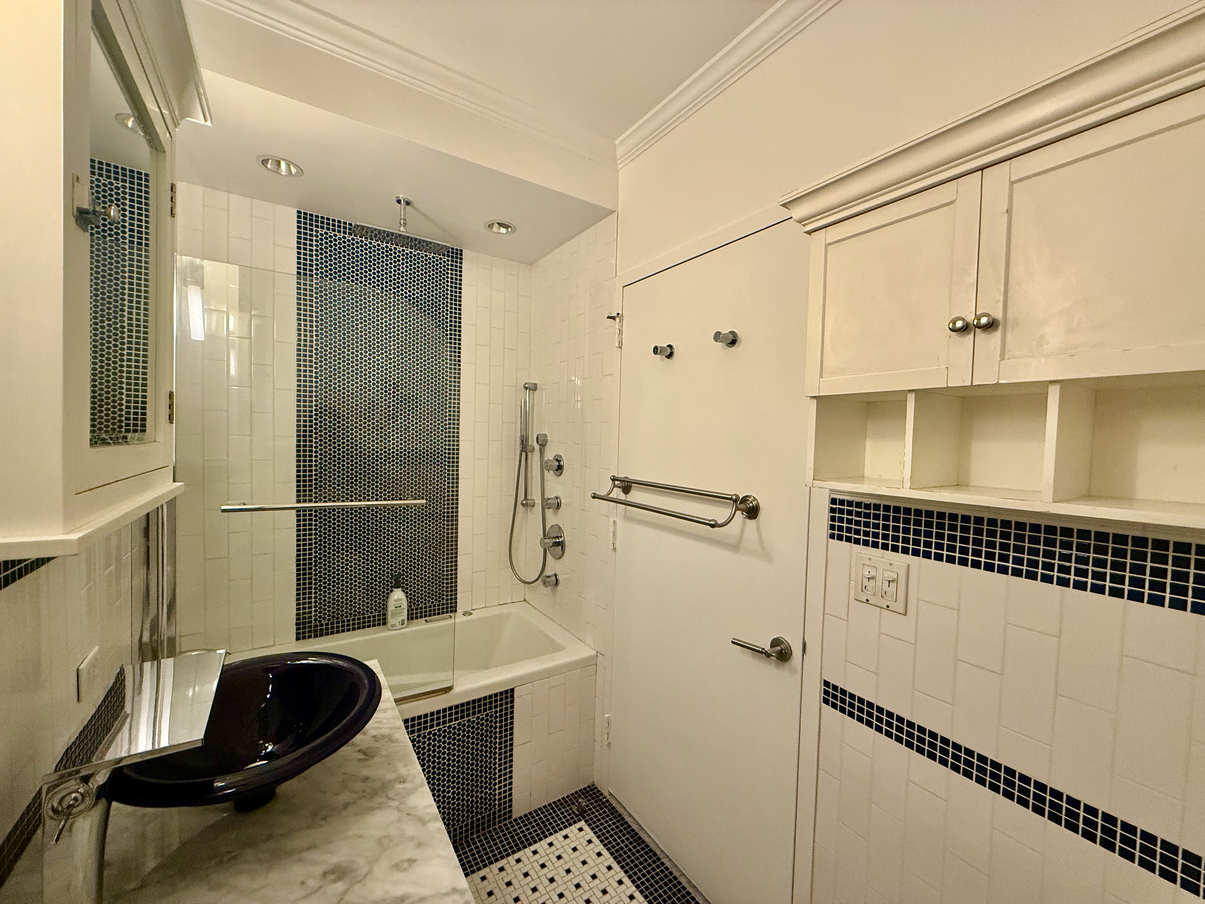 111 West 67th Street, Unit 22K Manhattan, NY 10023 - Photo 6 of 14 a bathroom with a sink a toilet and shower