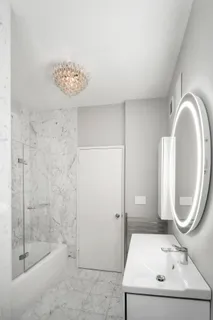 a bathroom with a sink a toilet and a mirror