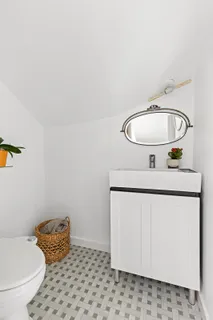 a bathroom with a toilet and a mirror