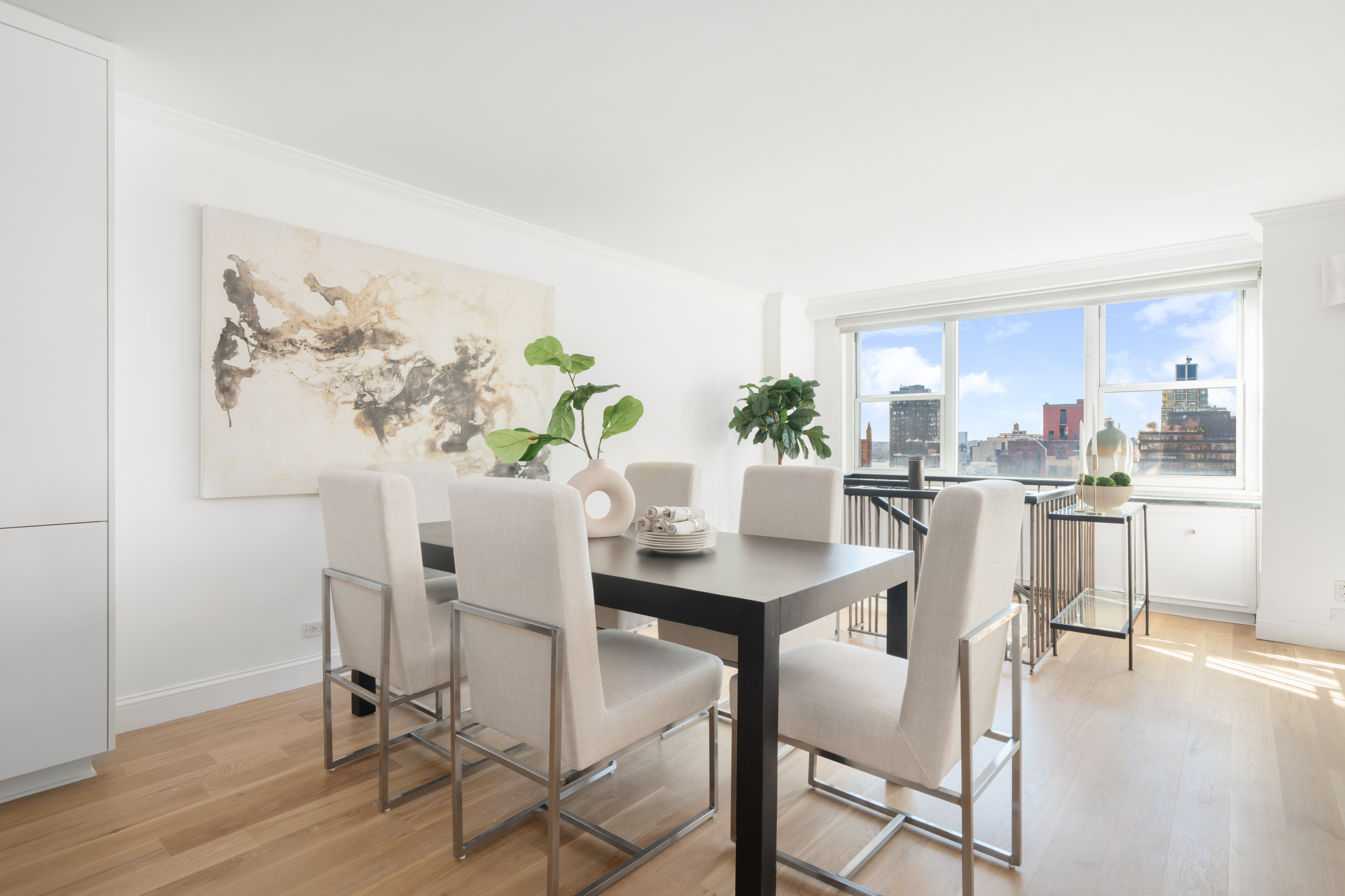 360 West 22nd Street, Unit 15C-14C Manhattan, NY 10011 - Photo 5 of 16 a view of a dining room with furniture and wooden floor