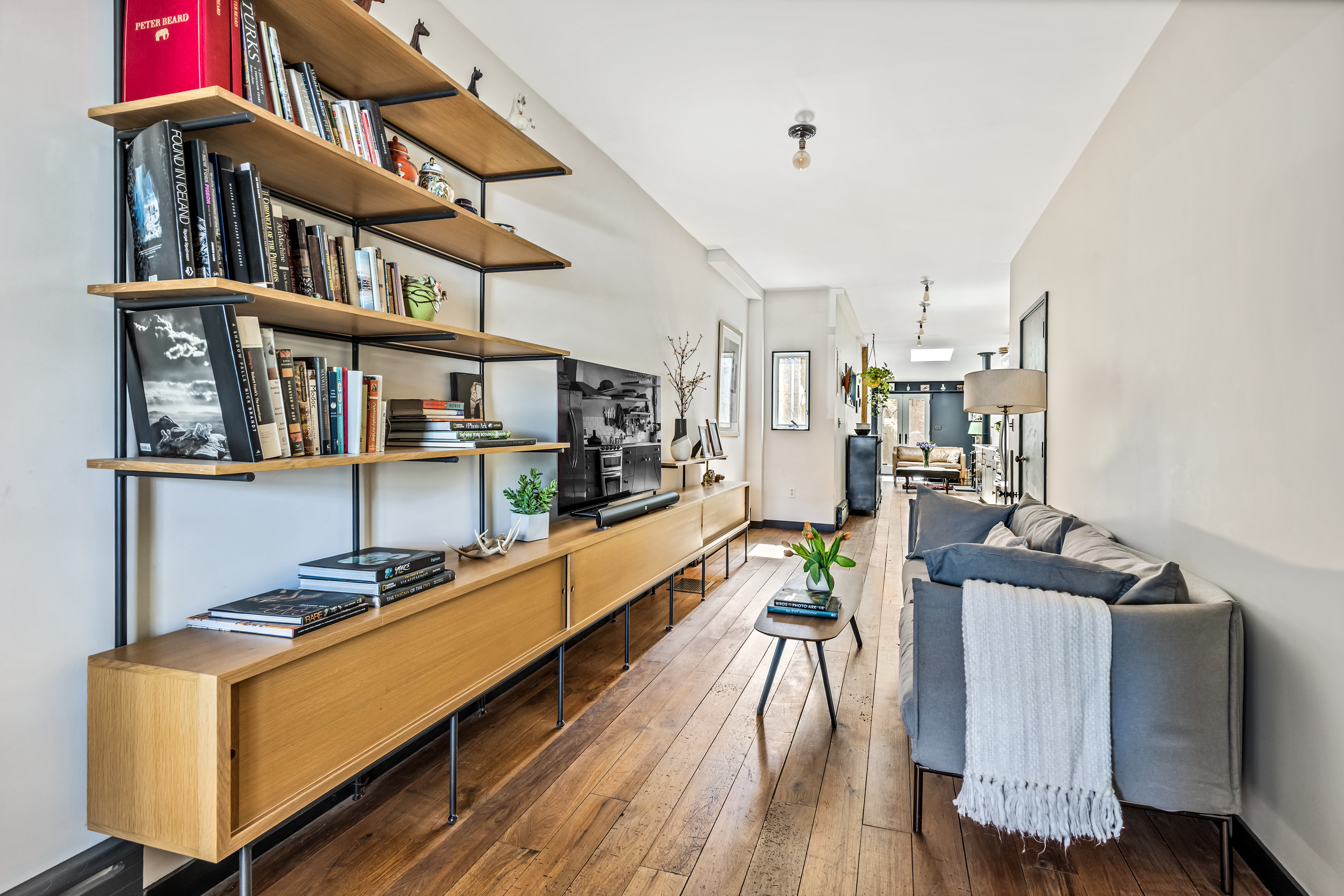 162 10th Street Brooklyn, NY 11215 - Photo 3 of 13 a room with furniture lots of wooden furniture and a book shelf