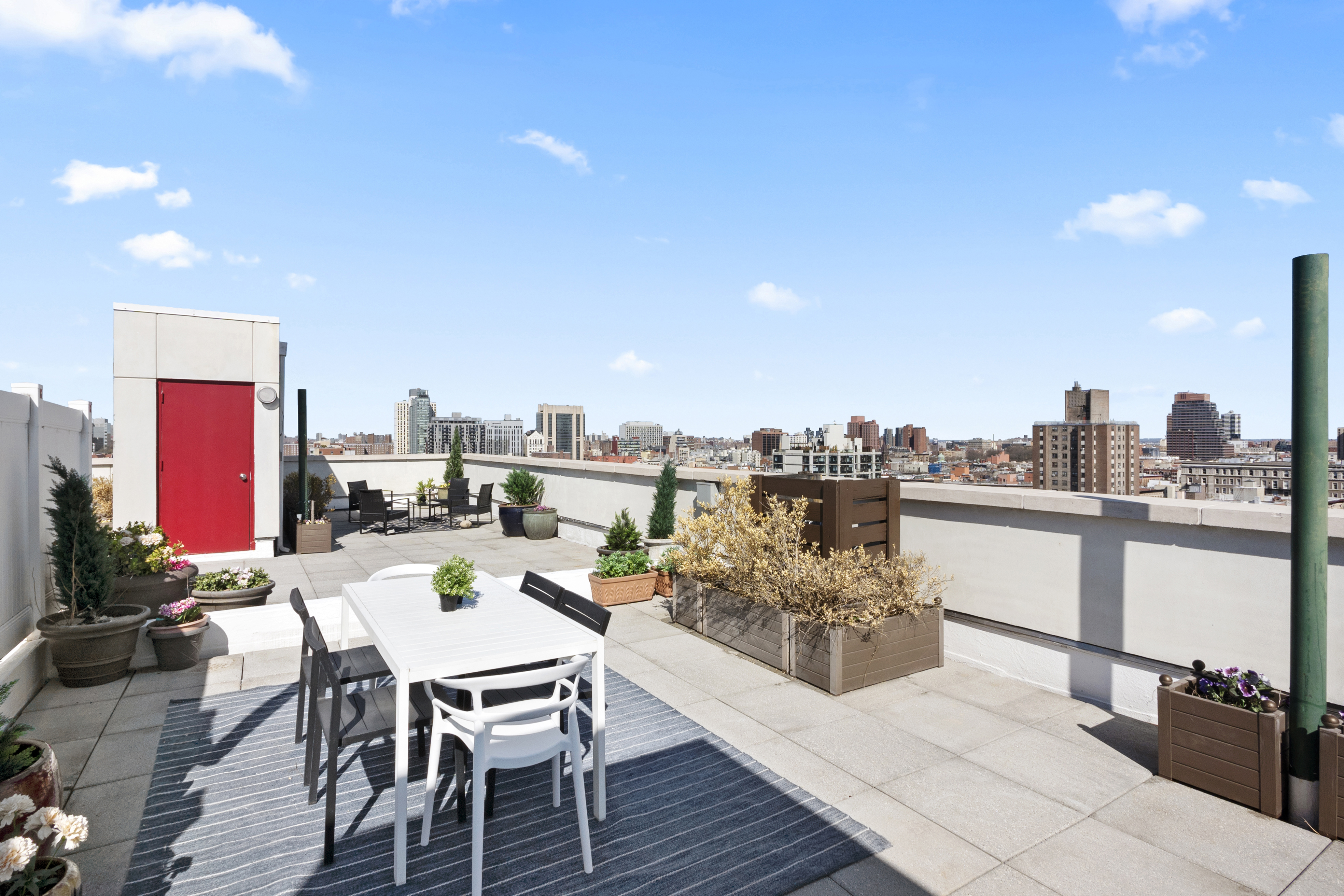 301 West 115th Street, Unit PH4C Manhattan, NY 10026 - Photo 12 of 15 a view of a terrace with furniture and a kitchen