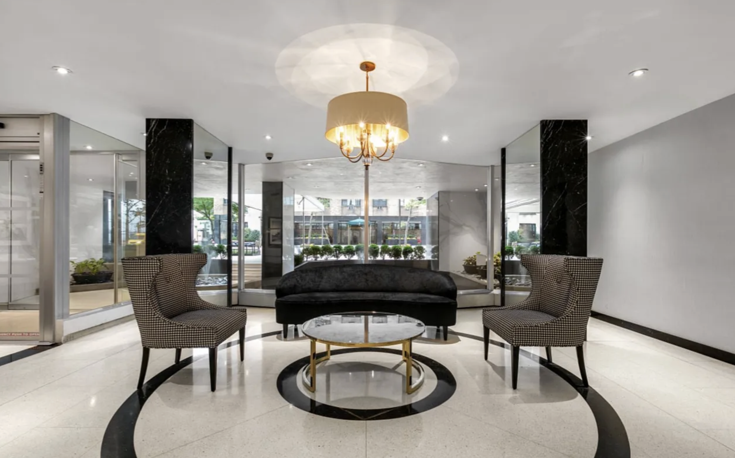 35 Sutton Place, Unit 10F Manhattan, NY 10022 - Photo 7 of 11 a living room with furniture and a chandelier